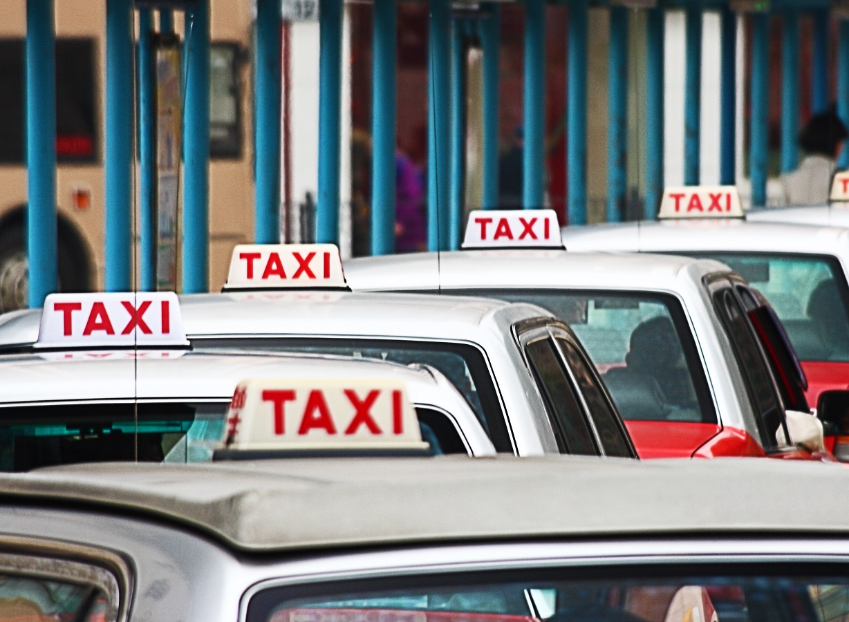 Line Of Taxis Waiting For Customers In Busy Hong Kong