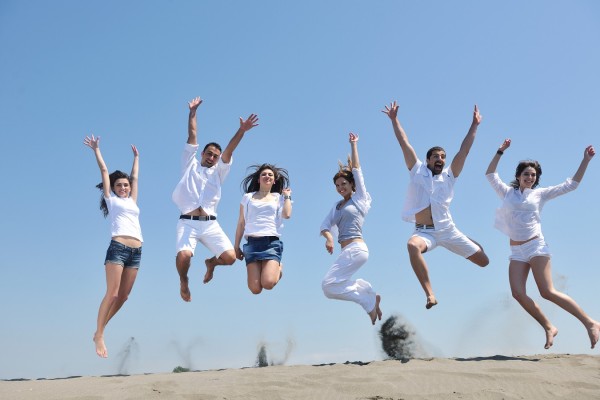 happy people group have fun and running on beach